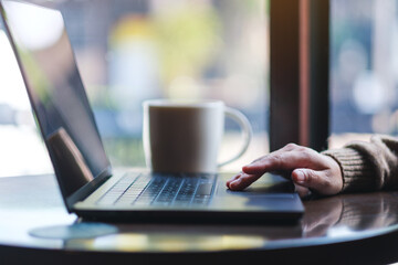 Closeup image of a hand working and touching on laptop computer touchpad
