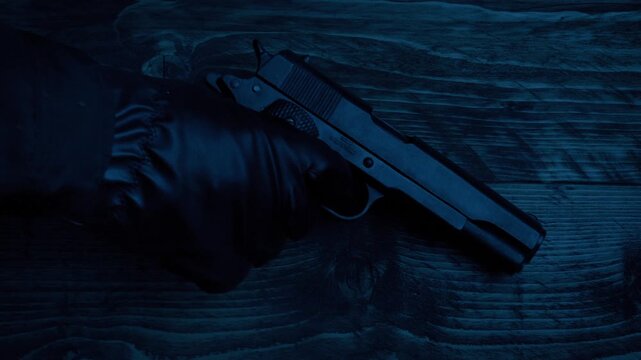 Gun Taken Or Put Down On Table In Dark Room