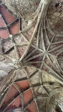 Ancient stone vaulted ceiling of a medieval monastery with gothic architecture details