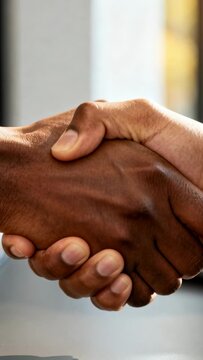 Vertical video: Shaking two hands initiating firm clasp as meeting starting in office, long sleeves