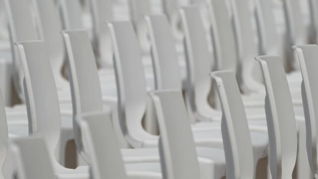 Large scale seating setup with many chairs prepared for an audience in a big event or conference environment.