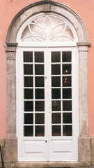 Obraz premium white arched door portugal pink facade classical building