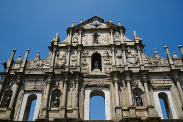 Fototapeta premium Iconic ruins of St Paul Cathedral historic stone facade with sculptures and carvings in Macau UNESCO heritage