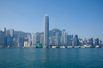 Obraz premium Panoramic Hong Kong island skyline with IFC tower and skyscrapers reflecting over Victoria Harbour water