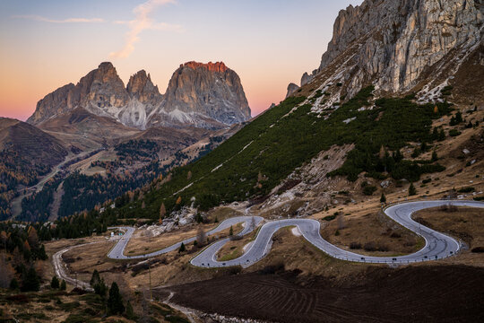 Scenic winding road of Pordoi Pass with Sassolungo Group at sunset