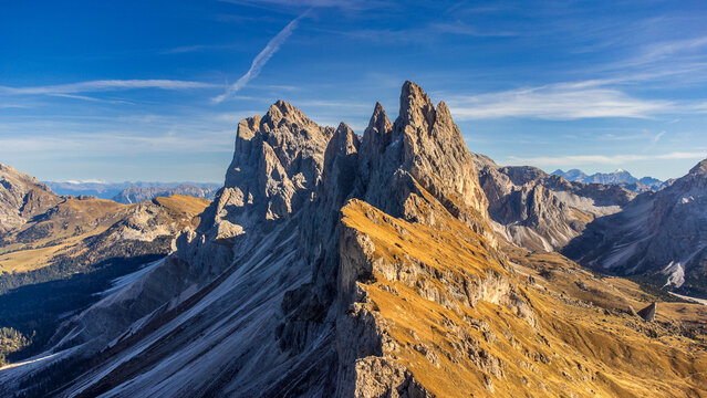 Autumn panoramic view of Mount Seceda and Odle in the Dolomites with golden meadows