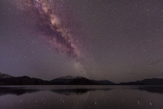 Night Scene, Wanaka lake with stars and Milky Way, stars mirroring in the water, Glendhu Bay, Otago, Southland, New Zealand