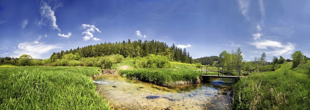 The small Anlauter River with a beaver dam and bridge meandering through the valley near Emsing in the Altmuehltal Valley Nature Park, Bavaria, Germany, Europe
