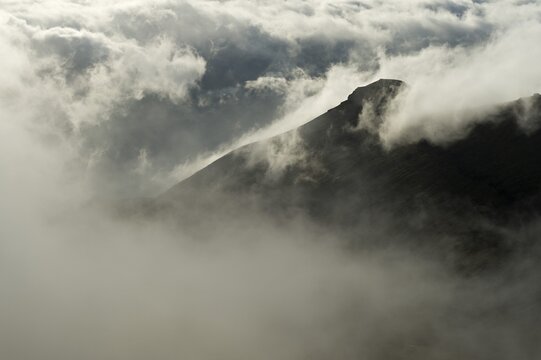 Clouds moving in, wispy clouds, summit area of Mt Sl&aelig;ttaratindur, Eysturoy, Faroe Islands, Denmark