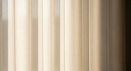 Fototapeta premium A close-up view of elegant cream-colored curtains with soft folds and gentle light filtering through