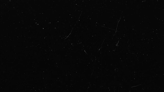 Dark background with white dust and subtle scratch marks