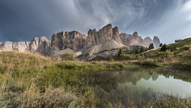 Sella Group with Piscadu reflected in a pond, Gardena Pass, Passo Gardena, nature park Park Puez Iceman, Dolomites, Selva di Val Gardena, South Tyrol, Trentino-Alto Adige, Italy