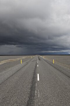 Thunderclouds forming over a highway, Skei&eth;ararsandur glacial outwash plain, southern coast of Iceland, Atlantic Ocean
