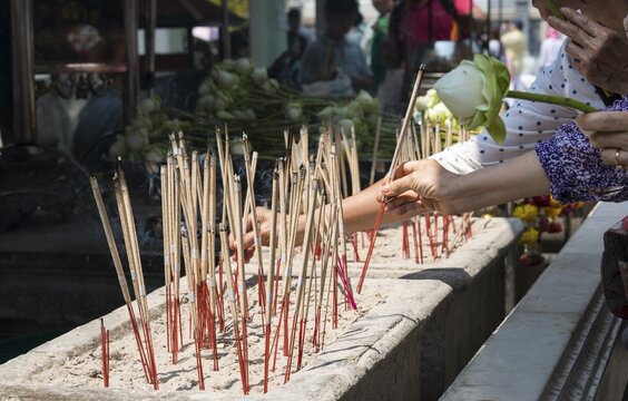 Believers lighting incense sticks, Wat Phra Kaeo Temple, Bangkok, Thailand