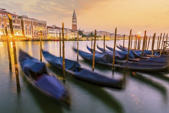 Evening atmosphere, sunset at the Grand Canal, gondolas at the pier, Campanile bell tower, Venice, Veneto region, Italy