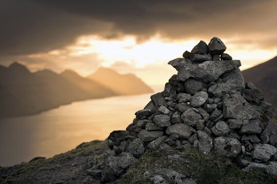 Cairn, dramatic mood lighting over the island of Kunoy, Bor&eth;oy, Nor&eth;oyar, Faroe Islands, Denmark