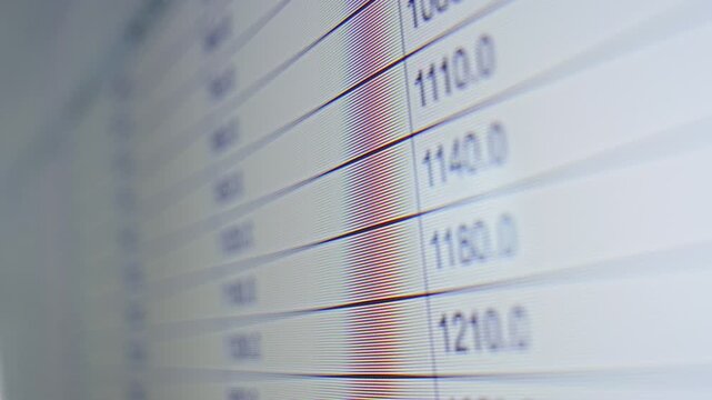 A laptop screen displaying a spreadsheet with neatly organized rows and columns of data. The table contains numbers and text arranged in cells, suggesting financial calculations or data analysis in