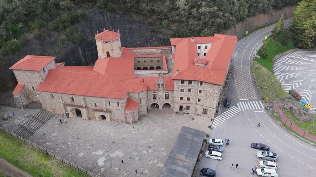 Aerial drone view of the stone exterior facade of Santo Toribio Monastery in Potes Cantabria Spain on a sunny day