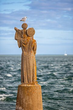 Seagull Rests on Historic Notre-Dame de Kerdro Statue, Brittany Coast