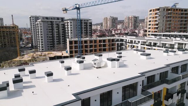 Aerial View of Modern Apartment Roof with Chimneys and Urban Skyline