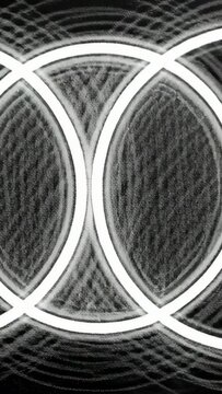 Vertical video: Panning camera across textured wall showing white rings, chalk marks and overlaps