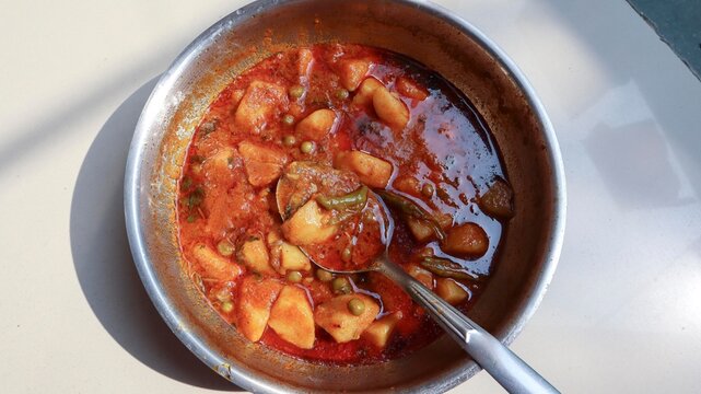 Indian popular homemade Aloo matar ki sabji. Side dish made of potatoes and green peas curry spicy and tasty