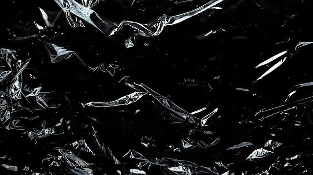 Abstract plastic wrap wrinkles illuminated with light for a dark moody aesthetic