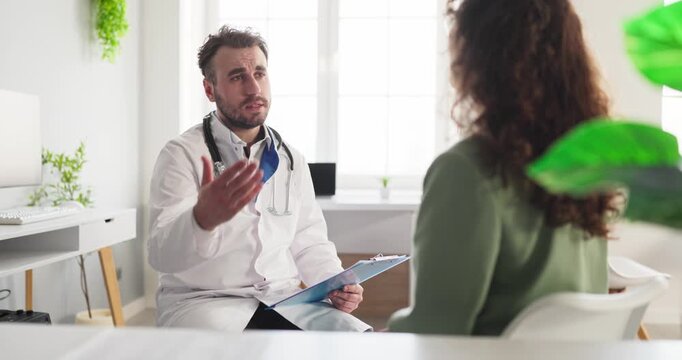 Doctor patient consultation in healthcare clinic. Male doctor explains diagnosis, medicine options, and offers clear advice during discussion and checkup. Trust, care, and clear guidance.