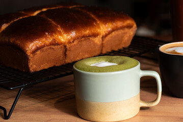 Coffee cups with delicious bread on a wooden table