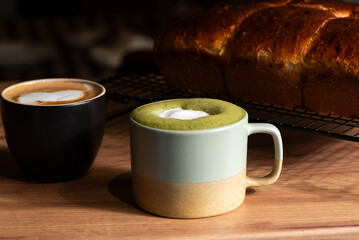 Coffee cups with delicious bread on a wooden table