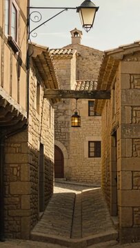 Camera pulling back from lantern, revealing stone facades and cobblestone alley to show charm