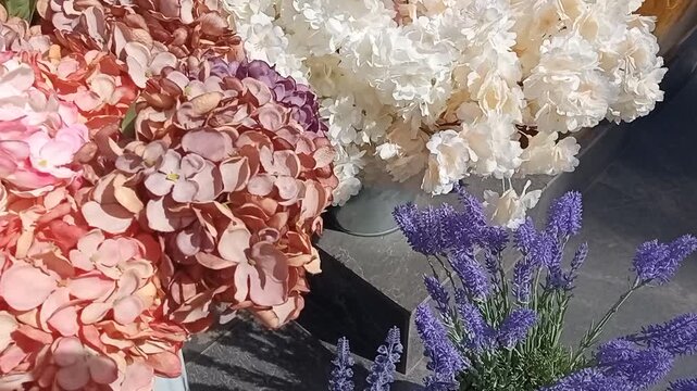 dense bouquets of various flowers in vases