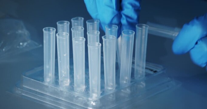 Laboratory technician pipetting sample solution for COVID-19 rapid antigen test in Berlin, Germany