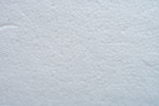 A high-resolution macro shot of white cold-pressed watercolor paper. The image showcases a distinct, heavy-grain textured surface with natural irregularities characteristic of high-quality cotton 
