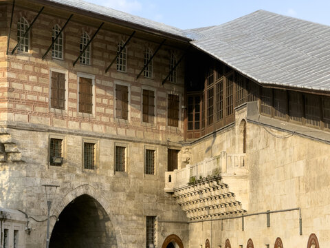 View of textured stone walls meet aged wooden window shutters under the eaves of historical architecture in the city, Istanbul, Istanbul, Turkey.