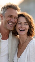 Obraz premium Smiling couple enjoying a joyful moment during a sunny outdoor setting.