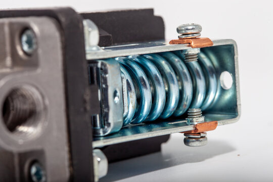 Top-down close-up of an air compressor pressure switch, showing the black plastic housing with technical specifications, a red round on-off power button, and a pressure regulator knob.