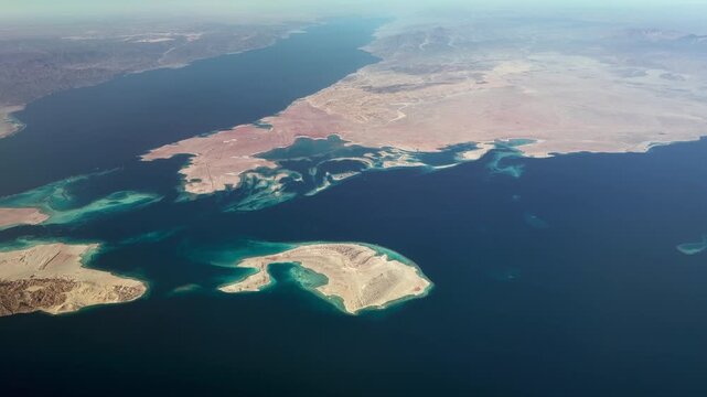 Aerial landscape view, flying along Sanafir Island , a Saudi Arabia island located in the Straits of Tirana which separates the Gulf of Aqaba from the Red Sea, with Ras Alsheikh Hamid a headland 