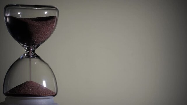 Hourglass flowing on white background. Left align composition with copy space on right, time management concept, minimalist product shot, hourglass in motion, clean style, steady flow
