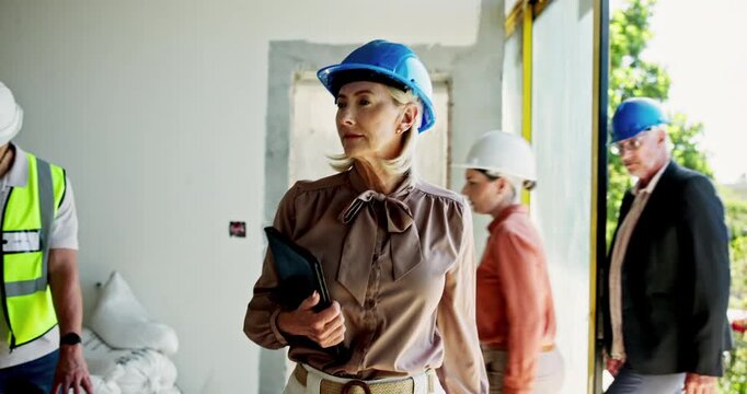 Architect, woman and walking with tablet at construction for inspection, project maintenance and progress. Mature, manager and check architecture with property development, demolition and renovation