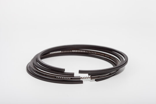 Engine piston rings set isolated on clean background, showing compression and oil control rings, ideal for automotive repair guides, spare parts catalogs or mechanical engineering concepts in engine m