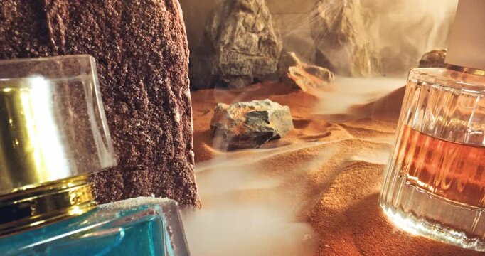 Unique amber perfumes in translucent glass bottle on sand.