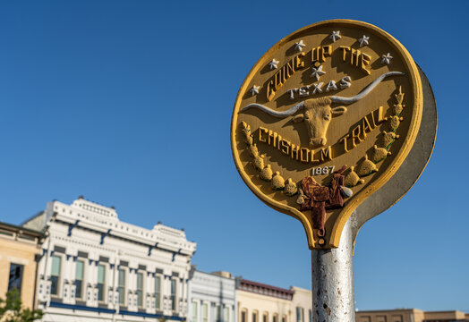 A historic marker stands in downtown Georgetown, Texas, highlighting the Chisholm Trail for visitors.