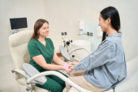 Female doctor supporting calm patient in medical examination room