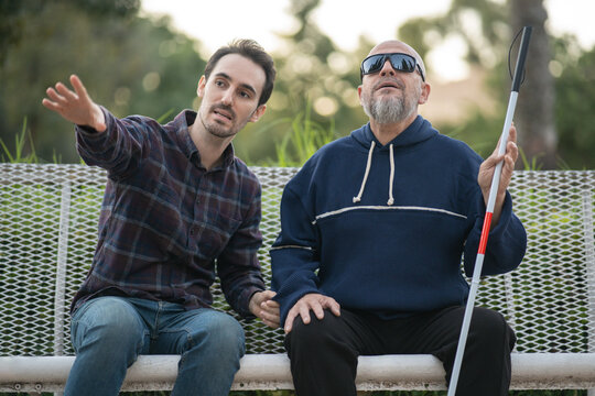 Assistant explaining to a blind person what is happening at that moment that they cannot see
