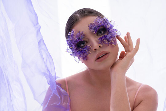 Enchanting beauty in a mystical setting adorned with delicate floral masks and soft fabrics