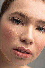 Fototapeta premium Captivating beauty shines through the expressive eyes of a young woman in soft lighting