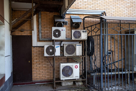 Russia. Moscow. March 22, 2026. Outdoor air conditioning units from Samsung, Panasonic, LG and General brands installed on a brick wall