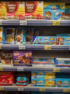 Izhevsk, Russia - February 26, 2026: Assorted packaged desserts and snacks on supermarket shelf featuring Mummy's Cake and Barni brand products in colorful packaging