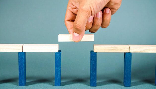 Hand placing block to bridge structural gap
